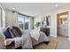 Stylish primary bedroom featuring a decorative ceiling fan and ensuite bathroom with modern finishes at 1259 Perry St, Denver, CO 80204