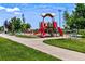 Bright and colorful playground with slides and climbing structures in a well-maintained community park with blue skies at 1259 Perry St, Denver, CO 80204