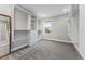 A spacious walk-in closet with ample built-in shelving and storage solutions, and neutral carpeting at 1259 Perry St, Denver, CO 80204