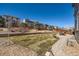 Large backyard with stone landscaping, a patio, and well-maintained lawn at 7506 Sabino Ln, Castle Rock, CO 80108