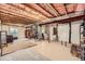 Unfinished basement with exposed beams, ample space, and potential for customization and storage at 7506 Sabino Ln, Castle Rock, CO 80108