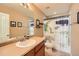 Updated bathroom features an updated single sink vanity with wood cabinets, updated fixtures, and a fun shower curtain at 7506 Sabino Ln, Castle Rock, CO 80108