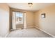 Bedroom with neutral walls and carpet features a window with curtains and a view of the neighborhood at 7506 Sabino Ln, Castle Rock, CO 80108
