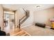 Carpeted entry space with hardwood flooring, and a view to the stairs and kitchen at 7506 Sabino Ln, Castle Rock, CO 80108