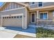Front exterior showcasing the covered porch, attached garage, and the home's architectural details at 7506 Sabino Ln, Castle Rock, CO 80108