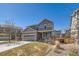 Charming two-story home with a well-manicured lawn, an attached garage, and inviting curb appeal at 7506 Sabino Ln, Castle Rock, CO 80108