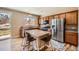 Kitchen island with seating, stainless steel appliances, and a view to the backyard at 7506 Sabino Ln, Castle Rock, CO 80108