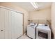 Bright laundry room features modern washer and dryer, with wire shelving and a sliding door at 7506 Sabino Ln, Castle Rock, CO 80108