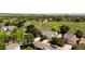 This aerial view shows a neighborhood and homes near a park with mature trees and a walking path at 11381 Jay St, Westminster, CO 80020