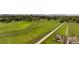An aerial view captures a community park with a green field and meandering walking path at 11381 Jay St, Westminster, CO 80020