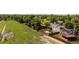 This aerial view captures a backyard with a treehouse, garden beds and a generous grassy area at 11381 Jay St, Westminster, CO 80020