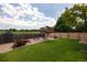 Large, private backyard featuring a fun treehouse, lush lawn, shed, and privacy fence at 11381 Jay St, Westminster, CO 80020