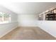 Open basement area with carpet and natural light from the window, adjacent to a stairwell at 11381 Jay St, Westminster, CO 80020