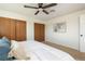 This bedroom features plush carpet, a ceiling fan, and multiple closets for ample storage space at 11381 Jay St, Westminster, CO 80020