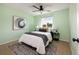 Comfortable bedroom with light green walls, ceiling fan, and neutral carpet creating a relaxing ambiance at 11381 Jay St, Westminster, CO 80020
