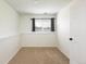 This carpeted bedroom has neutral paint and a window with dark curtains for a minimalist appeal at 11381 Jay St, Westminster, CO 80020