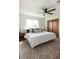 The primary bedroom has a spacious layout, ceiling fan, and large window for natural light at 11381 Jay St, Westminster, CO 80020
