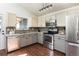 Well-lit kitchen with stainless steel appliances, gray cabinets, and ample counter space at 11381 Jay St, Westminster, CO 80020