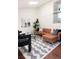 Bright living room boasts a leather sectional sofa, modern rug, and vaulted ceiling at 11381 Jay St, Westminster, CO 80020