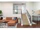 Spacious living room features a cozy sectional sofa, staircase, and decorative accents at 11381 Jay St, Westminster, CO 80020