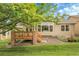 Lovely backyard featuring a well-kept lawn, a wooden deck, and mature trees for a peaceful retreat at 1033 Bramblewood Dr, Castle Pines, CO 80108