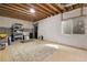 Unfinished basement featuring concrete walls, an exposed ceiling, and a window for natural light at 1033 Bramblewood Dr, Castle Pines, CO 80108