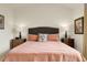 Comfortable bedroom featuring a bed with side tables and lamps, with neutral wall colors at 1033 Bramblewood Dr, Castle Pines, CO 80108