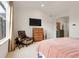 Bedroom with large window, furniture, TV, neutral wall colors, and carpet at 1033 Bramblewood Dr, Castle Pines, CO 80108