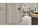 Entry to carpeted bedroom with a ceiling fan, natural light from windows, and neutral color scheme at 1033 Bramblewood Dr, Castle Pines, CO 80108