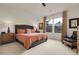 Comfortable carpeted bedroom with large windows, stylish curtains, and neutral wall color at 1033 Bramblewood Dr, Castle Pines, CO 80108