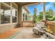 Cozy covered deck with comfortable seating and views of the backyard and surrounding greenery at 1033 Bramblewood Dr, Castle Pines, CO 80108