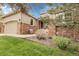 Home with inviting front porch with chair and red brick accents at 1033 Bramblewood Dr, Castle Pines, CO 80108