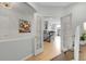 Bright hallway with access to living area through French doors at 1033 Bramblewood Dr, Castle Pines, CO 80108