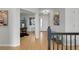 Hallway with hardwood floors leading to an office and front door at 1033 Bramblewood Dr, Castle Pines, CO 80108