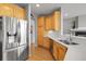 Modern kitchen featuring stainless steel appliances, quartz countertops, and wood floors at 1033 Bramblewood Dr, Castle Pines, CO 80108