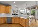 Open-concept kitchen with stainless steel appliances, white countertops, and dining area views at 1033 Bramblewood Dr, Castle Pines, CO 80108