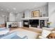 Cozy living room featuring a fireplace, hardwood floors, and modern decor at 1033 Bramblewood Dr, Castle Pines, CO 80108