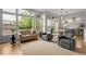 Bright and airy living room with large windows, hardwood floors, and stylish furniture at 1033 Bramblewood Dr, Castle Pines, CO 80108