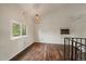 Bright living room with dark wood floors, light walls and interesting light fixture at 1909 Iola St, Aurora, CO 80010