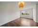 Bright living room featuring rich wood flooring, large window, and a unique pendant light fixture at 1909 Iola St, Aurora, CO 80010