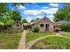 Backyard featuring a detached garage, garden, and well-maintained lawn at 4210 S Fox St, Englewood, CO 80110