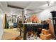 Large basement with visible beams, storage and a foosball table at 4210 S Fox St, Englewood, CO 80110