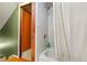 Bathroom features a shower over the tub with white tile surround and a doorway view at 4210 S Fox St, Englewood, CO 80110