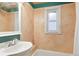 Bright bathroom featuring a window, and a tub with shower at 4210 S Fox St, Englewood, CO 80110