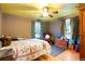 Bedroom with hardwood floors, ceiling fan, and a cozy atmosphere at 4210 S Fox St, Englewood, CO 80110