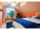 Cozy bedroom with large window, sloped ceilings, and comfortable furniture at 4210 S Fox St, Englewood, CO 80110