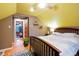 Charming bedroom features an exposed ceiling with fan and doorway view to a sunroom at 4210 S Fox St, Englewood, CO 80110