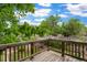View from a wood deck to the backyard with lush green trees in the summer at 4210 S Fox St, Englewood, CO 80110