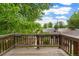 View from the wood deck to the surrounding neighborhood with lush green trees at 4210 S Fox St, Englewood, CO 80110