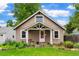 Quaint single-Gathering home with a covered front porch and beautiful flower beds at 4210 S Fox St, Englewood, CO 80110